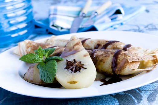 Rolled pancakes with poached pear