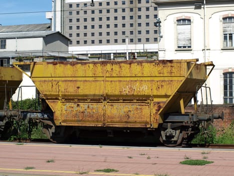 Yellow cargo train wagons at a station