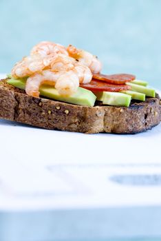 Brown toast with avocado, prawns and salami