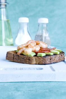 Brown toast with avocado, prawns and salami