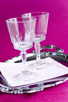 Wine glasses on pink background