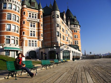 Tourist on Terrasse Dufferin in front of Chateau Frontenac - The most famous landmark in Quebec City.