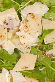 Fresh rocket salad with parmesan cheese and olive oil