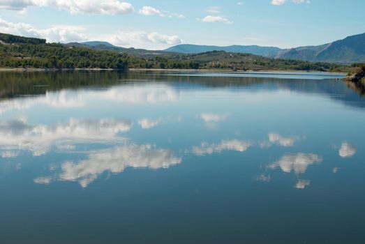 Morning sky mirroring in the waters of an idyllic lake