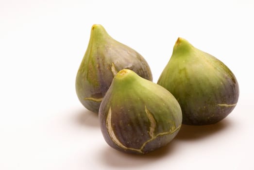 Three ripe figs,  fresh autumn fruit  on white