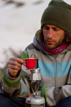 A cup of coffe outdoors. Caucasus mountains, june, freeride 