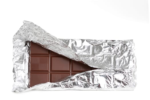 big milk chocolate bar wrapped in aluminium paper, isolated on white