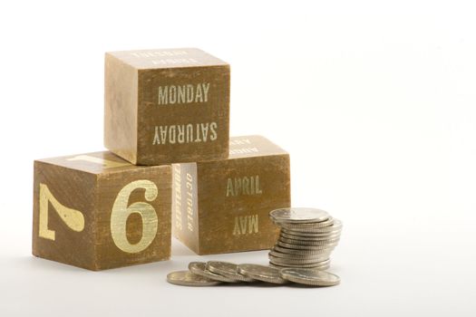 date blocks showing the start of the tax year 2009 with a pile of coins