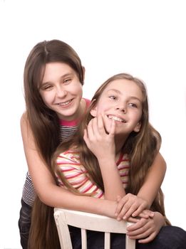 Two girls in the age of ten and eleven embracing hands isolated on white