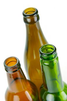 Empty beer bottles isolated against a white background