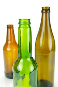 Empty beer bottles isolated against a white background