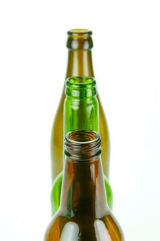 Empty beer bottles isolated against a white background