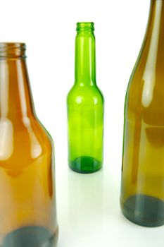 Empty beer bottles isolated against a white background