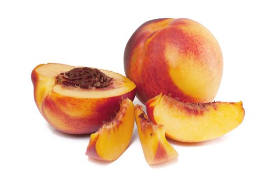 Tasty juicy peaches and slices of peaches on a white background