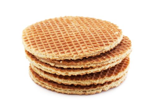 A stack of golden round waffles isolated over white background.