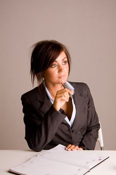 Young business woman writing in a diary