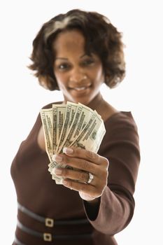 Portrait of woman holding twenty dollar bills in hand.