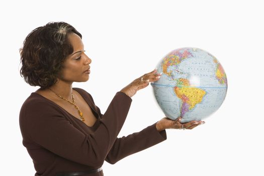 Woman holding world globe out between hands.