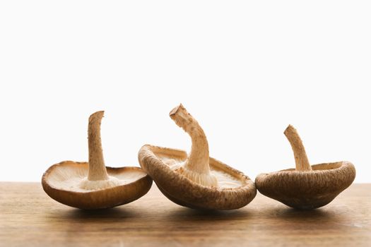 Three brown mushrooms upside down.