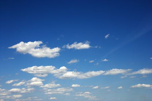 Fluffy clouds in blue sky.