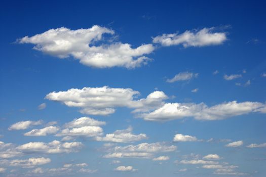 Cumulus clouds in blue sky.