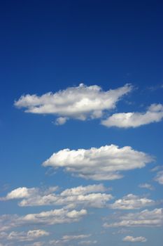 Fluffy clouds in blue sky.