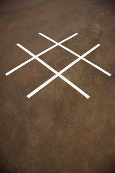 Tic tac toe game on playground concrete.