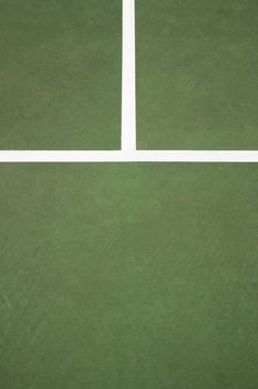 Close up of white lines on green concrete of tennis court.