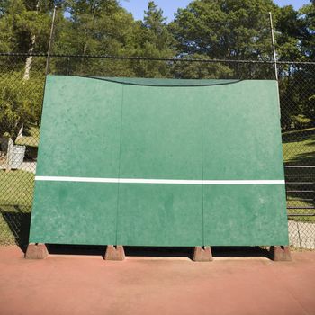 Tennis backboard for single practice in park.