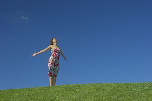 Happy woman having fun on a beautiful green meadow