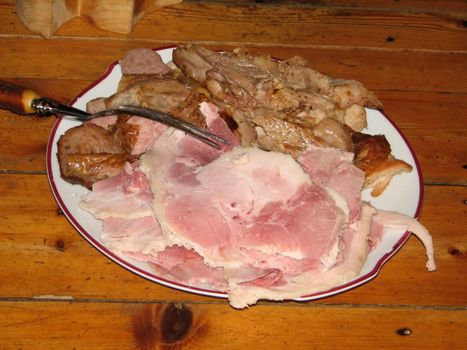 plate with ham on a wooden table