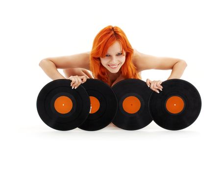 playful redhead with vinyl records over white