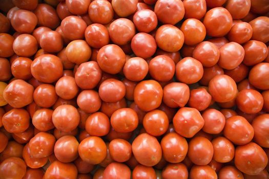 Pile of red tomatoes at produce market.