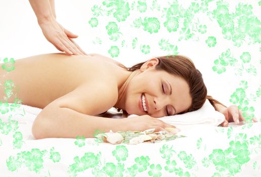 picture of lovely lady relaxing in massage salon with green flowers