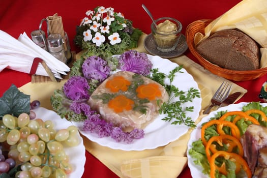 Celebratory table with meat products, fruit, vegetables and greens