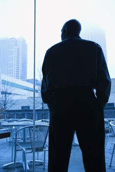 Mid-adult African American male looking out window.