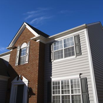 Exterior of brick and vinyl siding house.