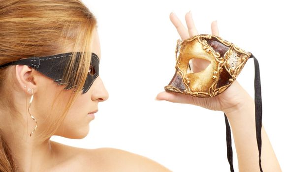 portrait of beautiful young woman holding venetian carnival mask