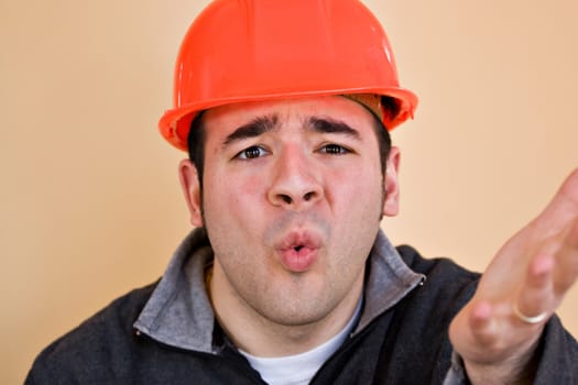 This construction worker is frustrated and confused about something.