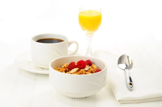 Breakfast of granola with fresh fruit and almonds.