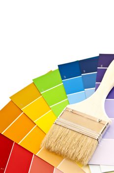 Clean paintbrush on rainbow of color card samples