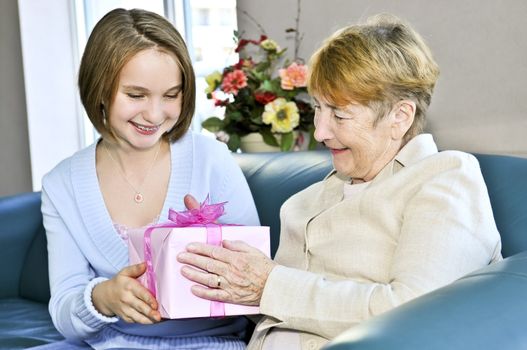 Granddaughter giving a present to her grandmother