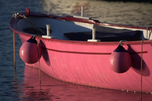 a pink boat moored in the port of Socoa near St Jean de Luz