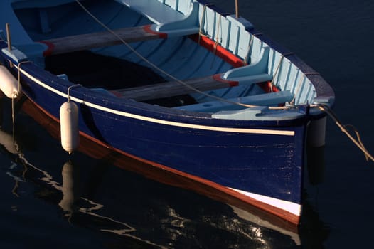 a blue boat moored in the port of Socoa near St Jean de Luz