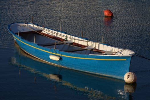 a blue boat moored in the port of Socoa near St Jean de Luz