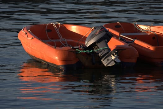 two inflatable boats motor into the harbor Socoa