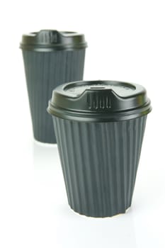 Takeaway coffee cups isolated against an orange background