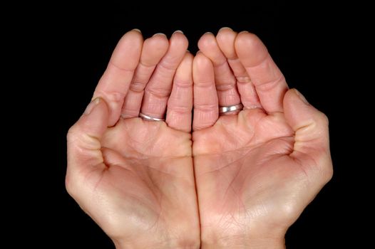 Woman is showing her open hands. On clean balck bagground.