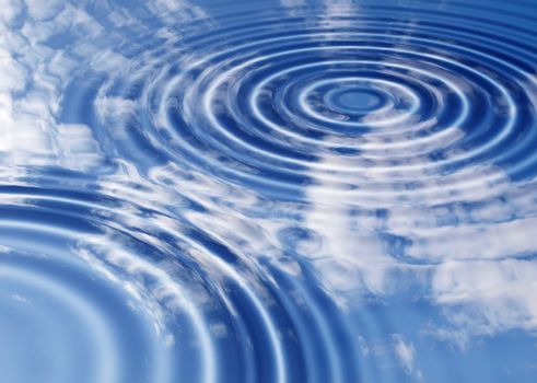 Blue sky with clouds reflected in a water pond