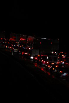 Traffic with cars and trucks. Taken at night.